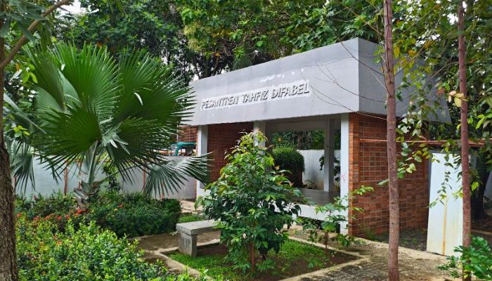 An inclusive Pesantren Tahfiz Difabel building designed for students with disabilities, featuring universal design principles such as accessible ramps, guiding blocks, and disability-friendly facilities.