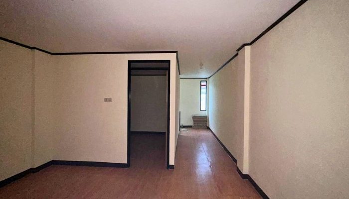 A sustainable urban housing project featuring compact modern residences, a pedestrian-friendly environment, and a landscaped public space with a pond and greenery. The area integrates eco-friendly elements such as green facades, vertical gardens, and natural ventilation.