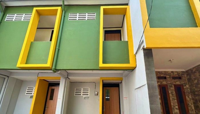 A sustainable urban housing project featuring compact modern residences, a pedestrian-friendly environment, and a landscaped public space with a pond and greenery. The area integrates eco-friendly elements such as green facades, vertical gardens, and natural ventilation.