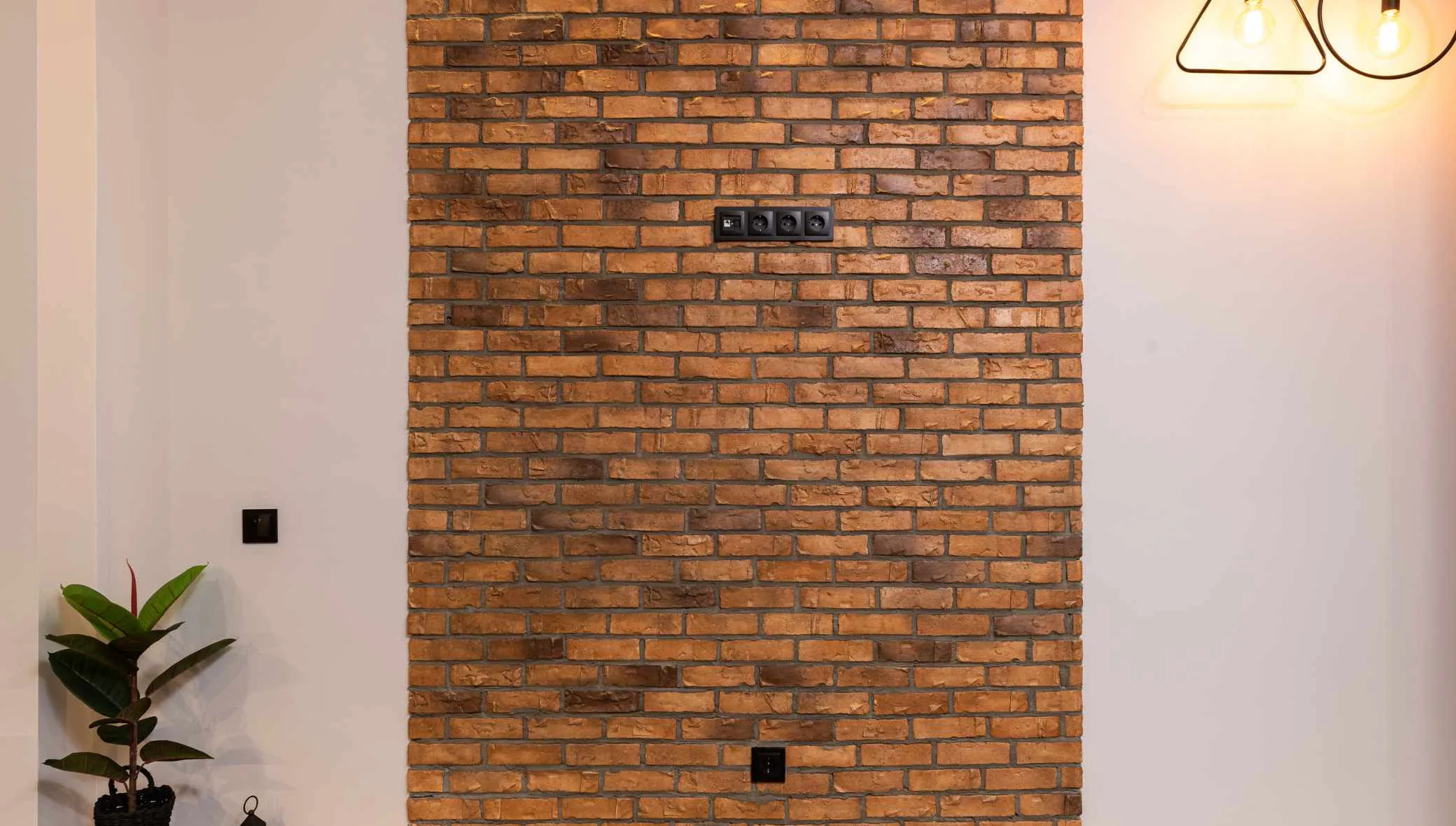 A contemporary living room featuring an exposed brick accent wall