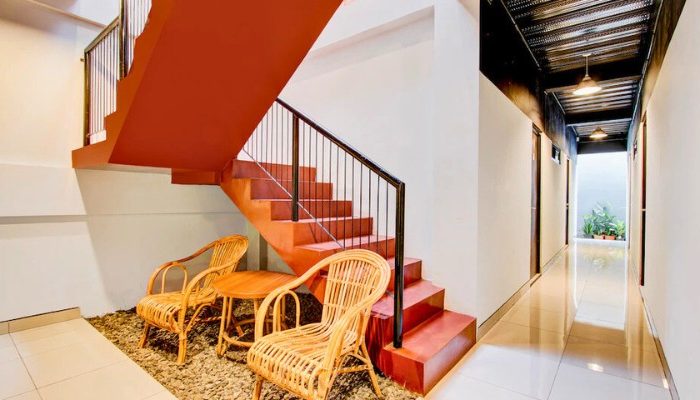 The facade of Rubina Hotel - Purbalingga with a mix of wood, stone, and glass materials, presents a modern tropical concept that is elegant and sustainable.