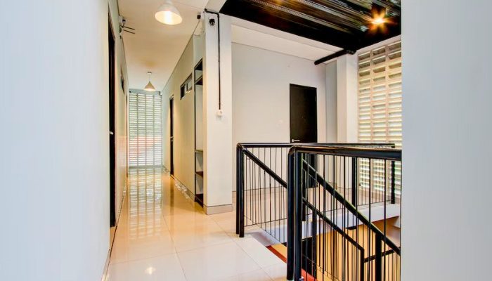 The facade of Rubina Hotel - Purbalingga with a mix of wood, stone, and glass materials, presents a modern tropical concept that is elegant and sustainable.