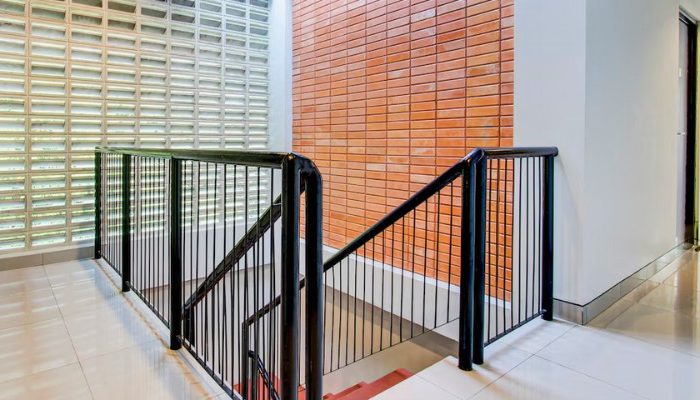 The facade of Rubina Hotel - Purbalingga with a mix of wood, stone, and glass materials, presents a modern tropical concept that is elegant and sustainable.