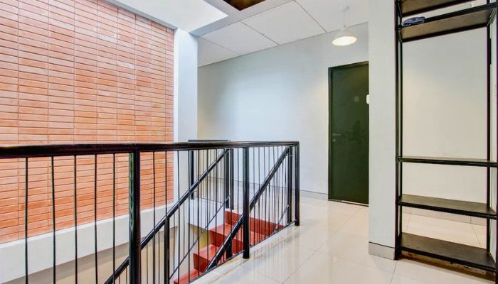 The facade of Rubina Hotel - Purbalingga with a mix of wood, stone, and glass materials, presents a modern tropical concept that is elegant and sustainable.