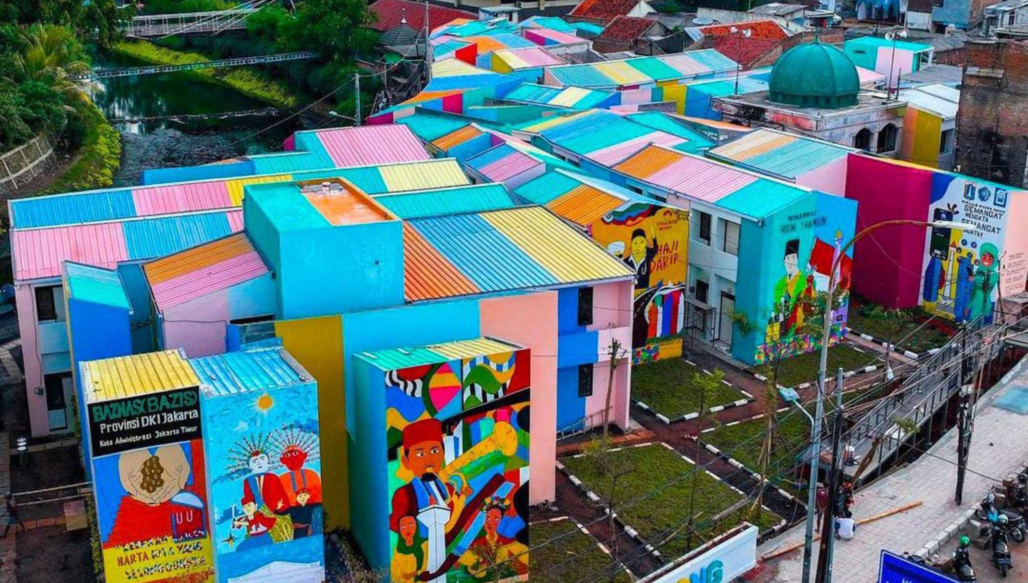 Community space and colorful housing facades in Kampung Gembira Gembrong after revitalization.