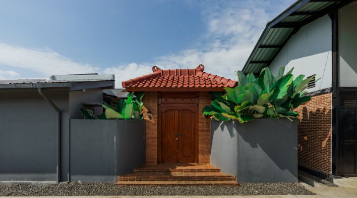 Modern residential and industrial buildings in Purbalingga featuring traditional red brick gates and tropical industrial design by YPA Architecture Studio in 2024.