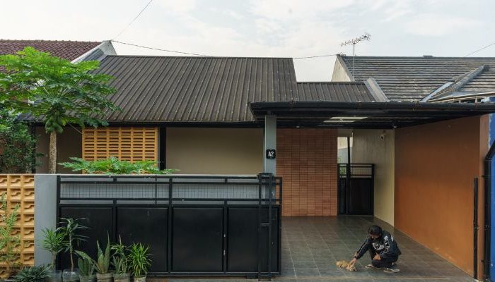 A modern tropical house with lattice walls, a green garden, and natural lighting in Purbalingga, designed by YPA Architecture Studio in 2024.