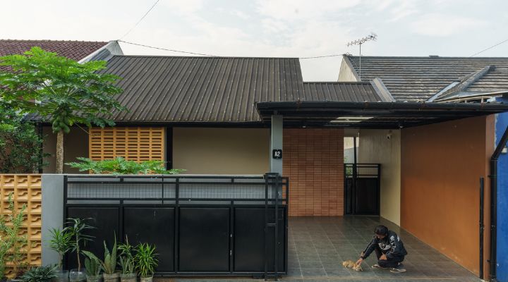 A modern tropical house with lattice walls, a green garden, and natural lighting in Purbalingga, designed by YPA Architecture Studio in 2024.