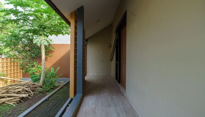 A modern tropical house with lattice walls, a green garden, and natural lighting in Purbalingga, designed by YPA Architecture Studio in 2024.