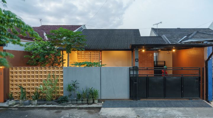 A modern tropical house with lattice walls, a green garden, and natural lighting in Purbalingga, designed by YPA Architecture Studio in 2024.