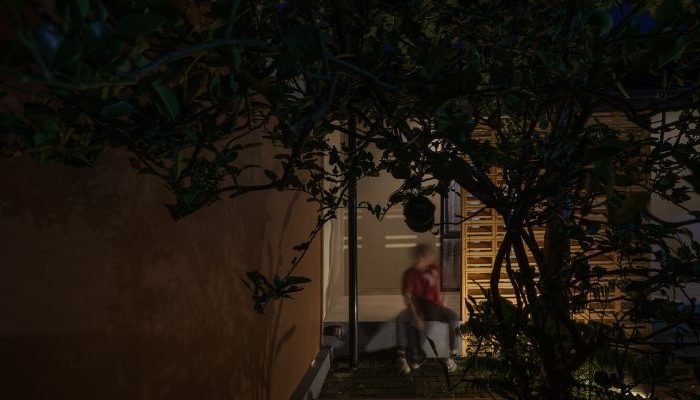 A modern tropical house with lattice walls, a green garden, and natural lighting in Purbalingga, designed by YPA Architecture Studio in 2024.