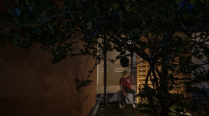 A modern tropical house with lattice walls, a green garden, and natural lighting in Purbalingga, designed by YPA Architecture Studio in 2024.