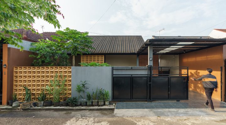 A modern tropical house with lattice walls, a green garden, and natural lighting in Purbalingga, designed by YPA Architecture Studio in 2024.