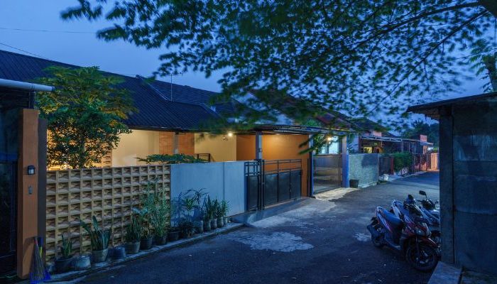 A modern tropical house with lattice walls, a green garden, and natural lighting in Purbalingga, designed by YPA Architecture Studio in 2024.