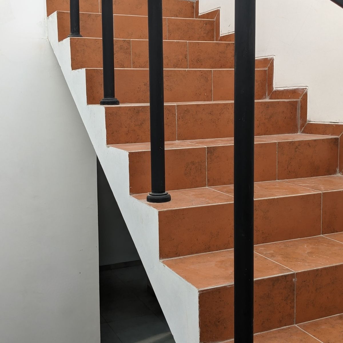 Proyek Adhara House di Tangerang Selatan karya YPA Architecture Studio dan Barakaja Construction menampilkan fasad modern dengan aksen merah, dinding roster beton, dan inner courtyard minimalis dengan kolam air yang terintegrasi dengan interior rumah yang luas.